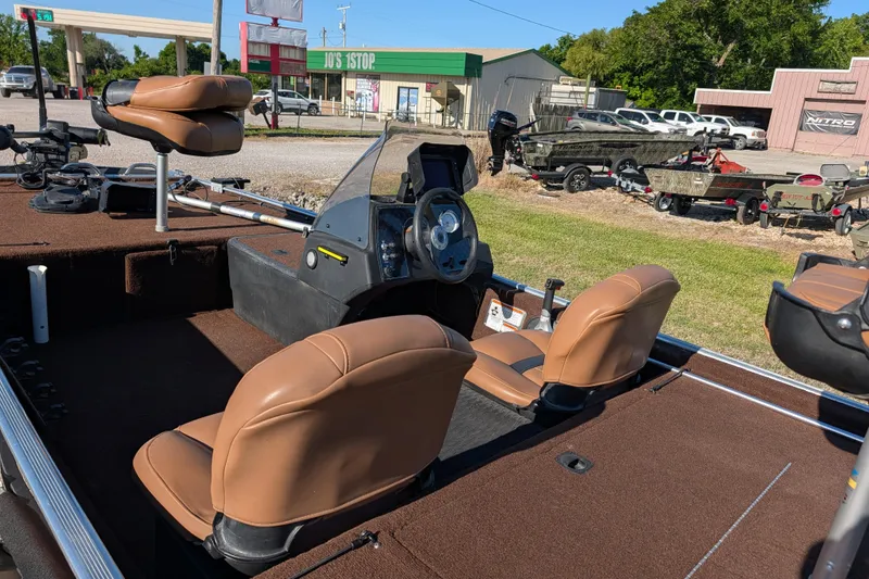 Slide: The Image of 2018 Tracker Bass Tracker 40th Anniversary Heritage Edition boat interior with brown seats and steering console. - 18