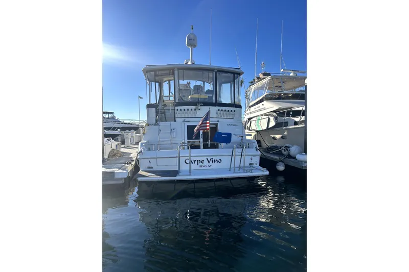 Slide: The Image of 1997 Carver 430 Cockpit Motor Yacht docked at marina, sunny day, rear view. - 1