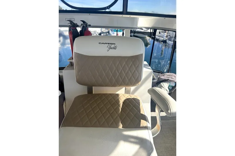 Slide: The Image of Captain's chair on 1997 Carver 430 Cockpit Motor Yacht, featuring quilted upholstery. - 12
