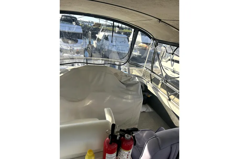 Slide: The Image of 1997 Carver 430 Cockpit Motor Yacht interior with fire extinguishers and marina view. - 13