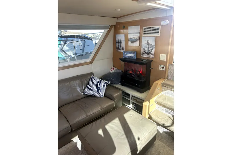 Slide: The Image of Interior of 1997 Carver 430 Cockpit Motor Yacht with cozy seating and decorative fireplace. - 15