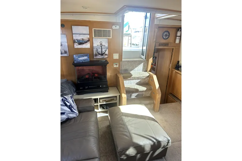 Slide: The Image of Interior of 1997 Carver 430 Cockpit Motor Yacht with cozy seating and decorative elements. - 16