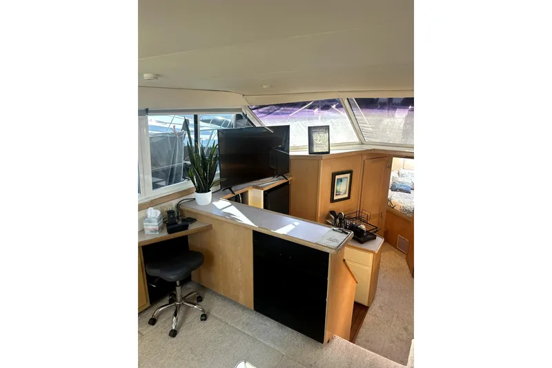 Slide: The Image of Interior of 1997 Carver 430 Cockpit Motor Yacht with modern decor and natural light. - 18