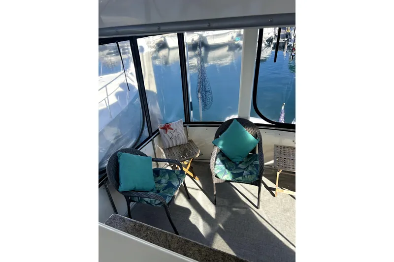 Slide: The Image of Interior of 1997 Carver 430 Cockpit Motor Yacht with cozy seating and marina view. - 20