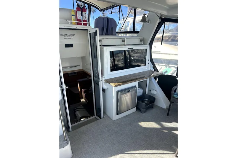 Slide: The Image of Interior of 1997 Carver 430 Cockpit Motor Yacht with kitchenette and seating area. - 21