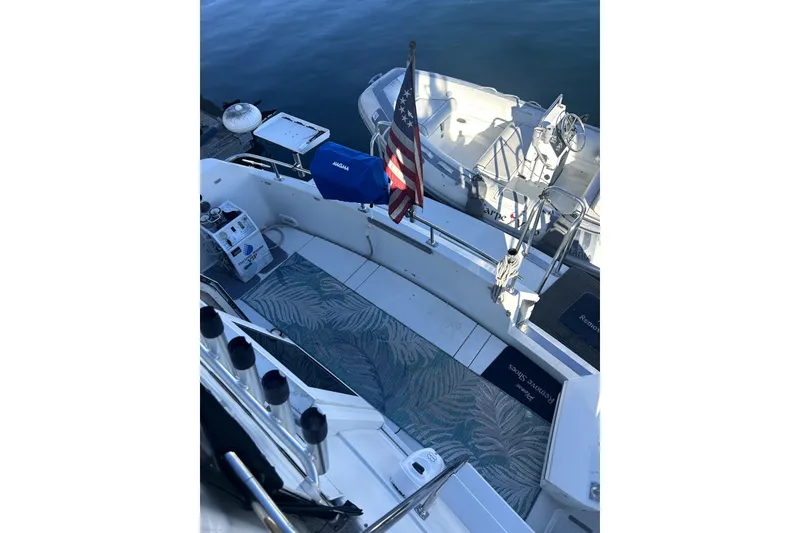 Slide: The Image of 1997 Carver 430 Cockpit Motor Yacht with American flag, very nice dinghy is available for an aditional cost if desired. - 25