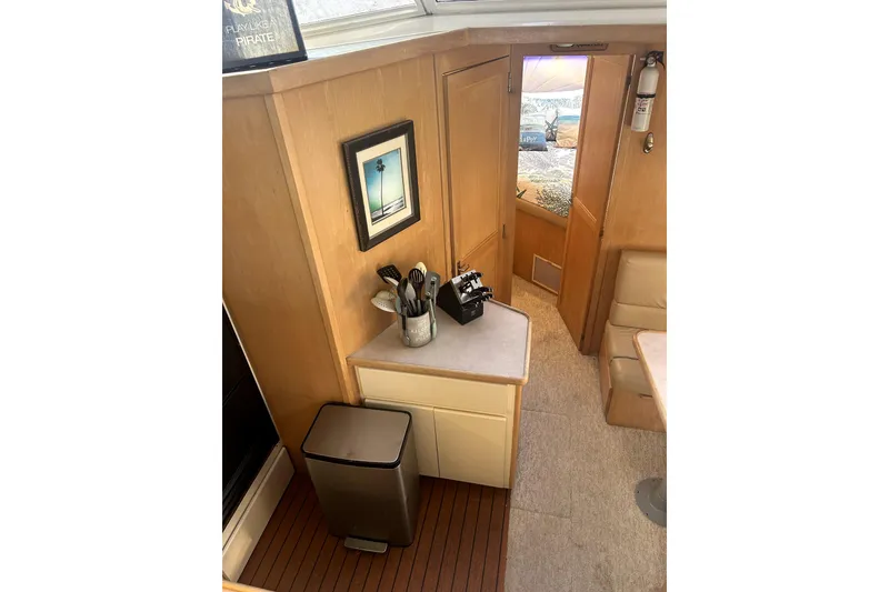 Slide: The Image of Interior of 1997 Carver 430 Cockpit Motor Yacht with kitchenette and seating area. - 3