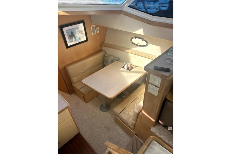 Slide: The Image of Interior of 1997 Carver 430 Cockpit Motor Yacht with cozy dining area. - 5