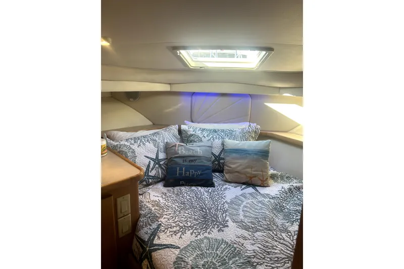 Slide: The Image of Cozy bedroom in 1997 Carver 430 Cockpit Motor Yacht with nautical-themed decor. - 7
