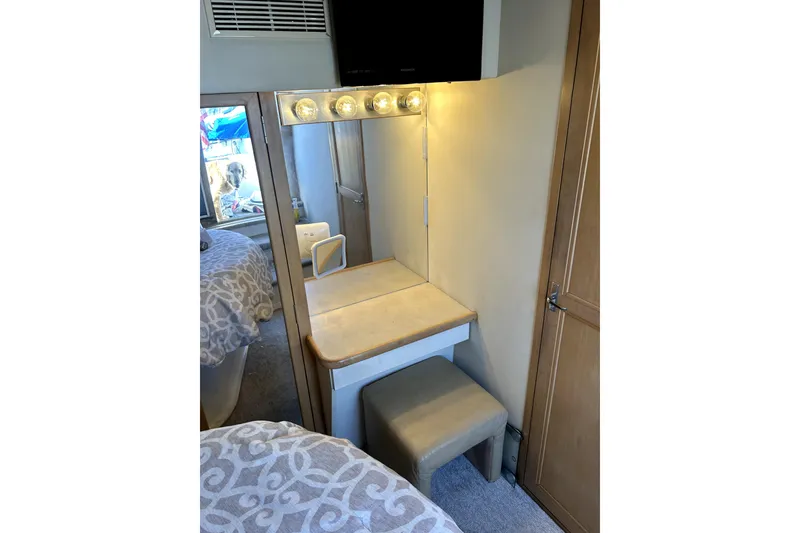 Slide: The Image of Vanity area in 1997 Carver 430 Cockpit Motor Yacht with mirror and cushioned stool. - 8
