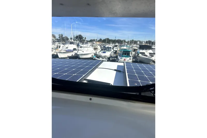 Slide: The Image of 1997 Carver 430 Cockpit Motor Yacht with solar panels, docked at a marina. - 9