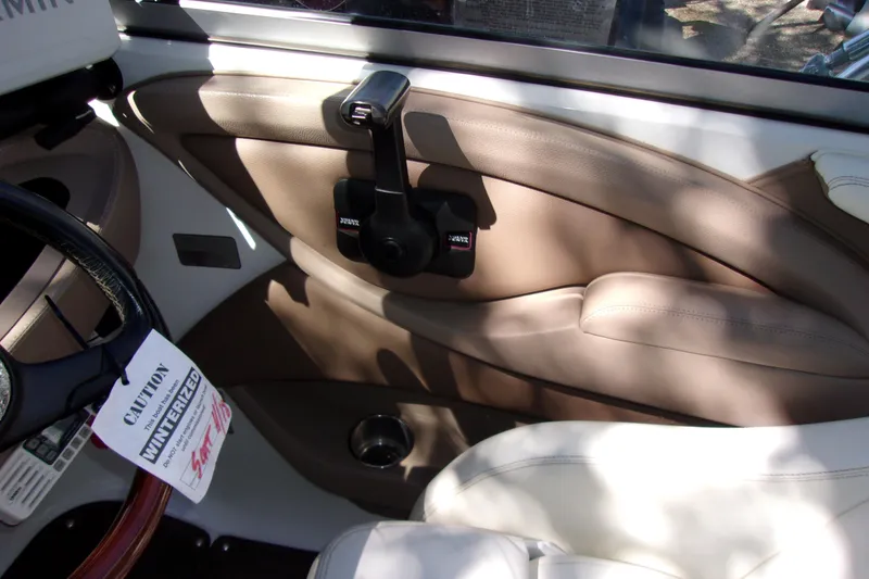 Slide: The Image of Interior of a 2007 Cobalt 222 boat, featuring beige leather seating and control panel. - 11
