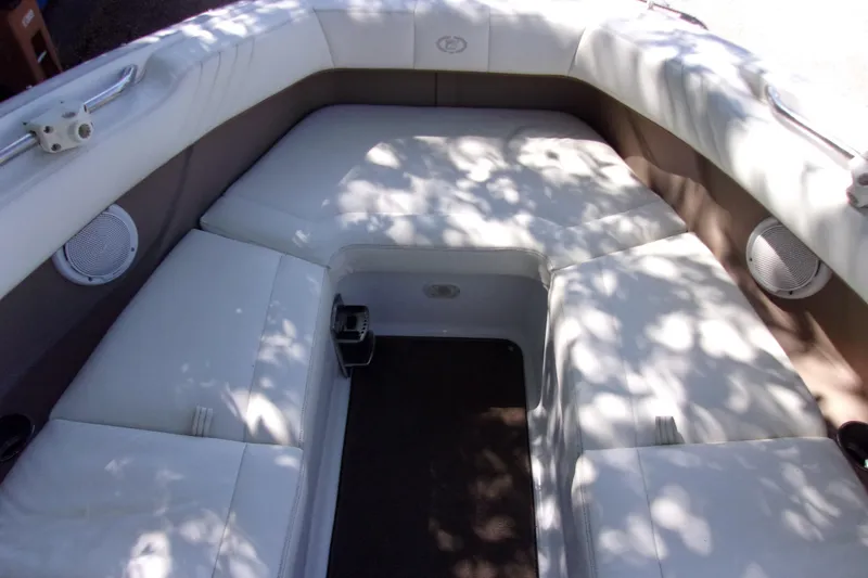Slide: The Image of Interior seating of a 2007 Cobalt 222 boat, featuring white upholstery and built-in speakers. - 12