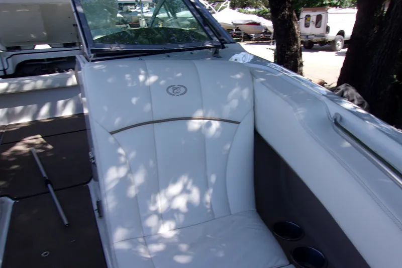 Slide: The Image of Interior of a 2007 Cobalt 222 boat with white seating and cup holders. - 13