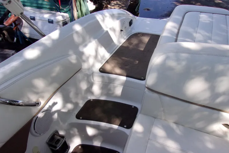 Slide: The Image of Interior of a 2007 Cobalt 222 boat with white seating and shadow patterns. - 18