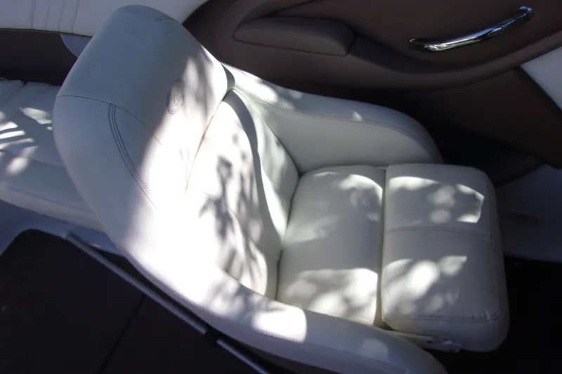 Slide: The Image of White leather seat in a 2007 Cobalt 222 boat, with sunlight and shadows. - 9