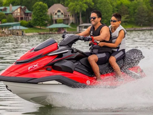 Slide: The Image of Father and son riding 2026 Yamaha WaveRunner FX Cruiser HO on a lake. - 3