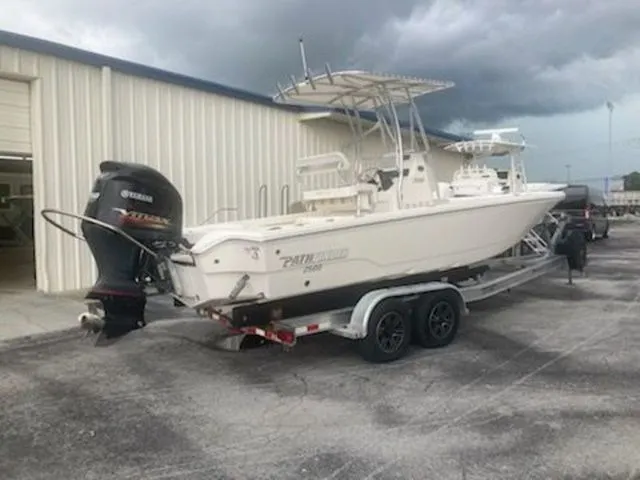The Image of 2020 Pathfinder 2500 Hybrid boat on trailer near warehouse. - 1