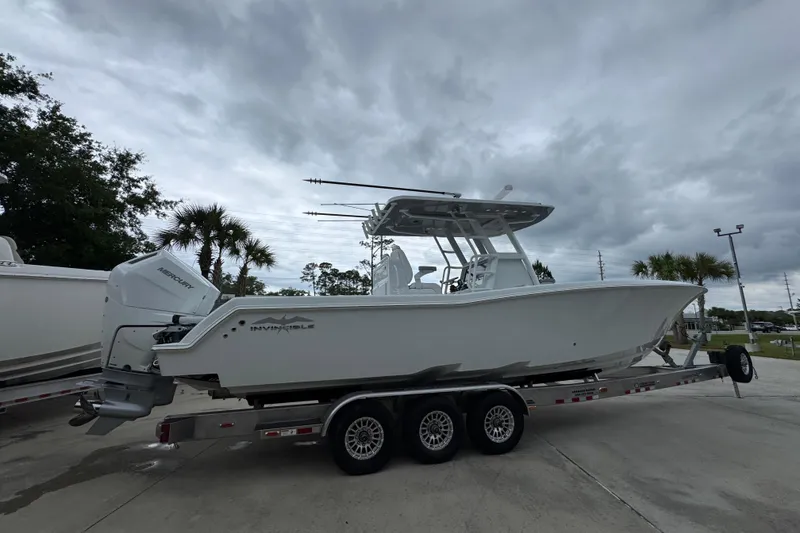 Slide: The Image of 2026 Invincible 33 Open Fisherman boat on trailer under cloudy sky. - 10