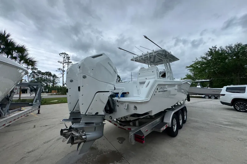 Slide: The Image of 2026 Invincible 33 Open Fisherman boat with dual outboard engines on a trailer. - 12