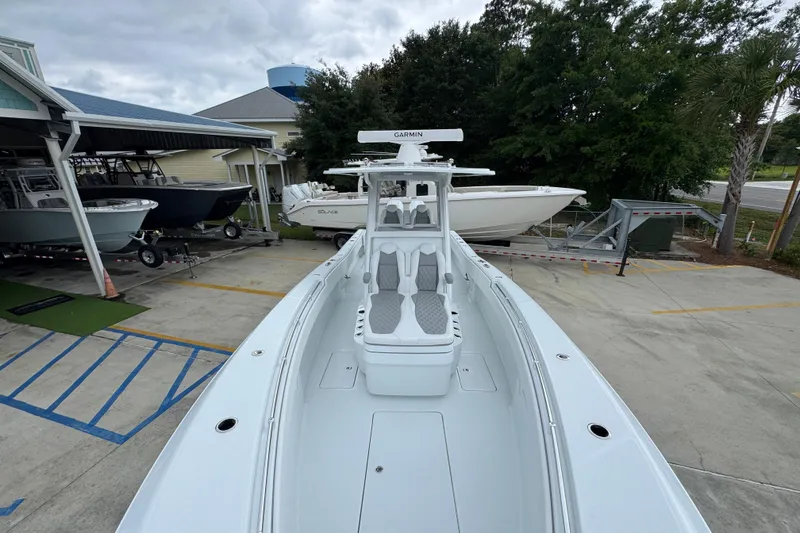 Slide: The Image of 2026 Invincible 33 Open Fisherman boat docked, showcasing sleek design and advanced features. - 21
