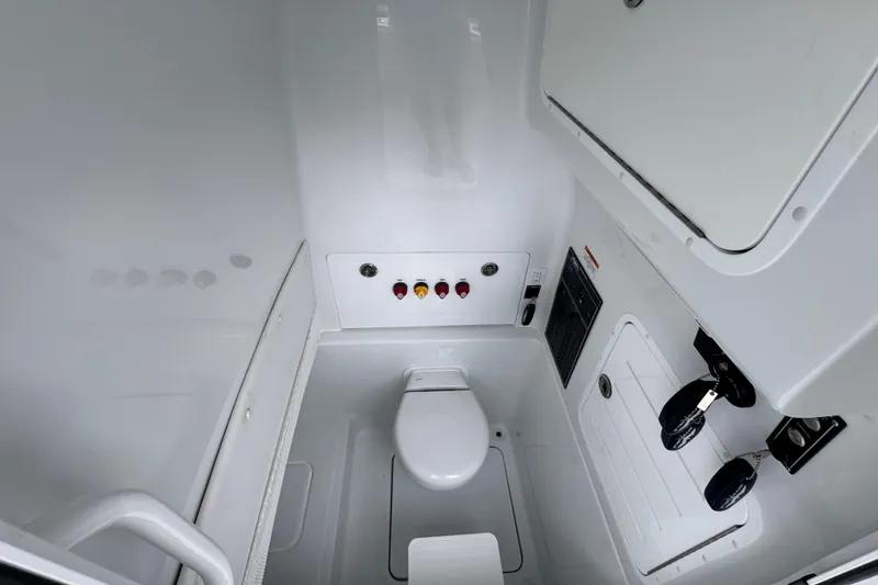 Slide: The Image of 2026 Invincible 33 Open Fisherman boat interior with compact marine toilet. - 26