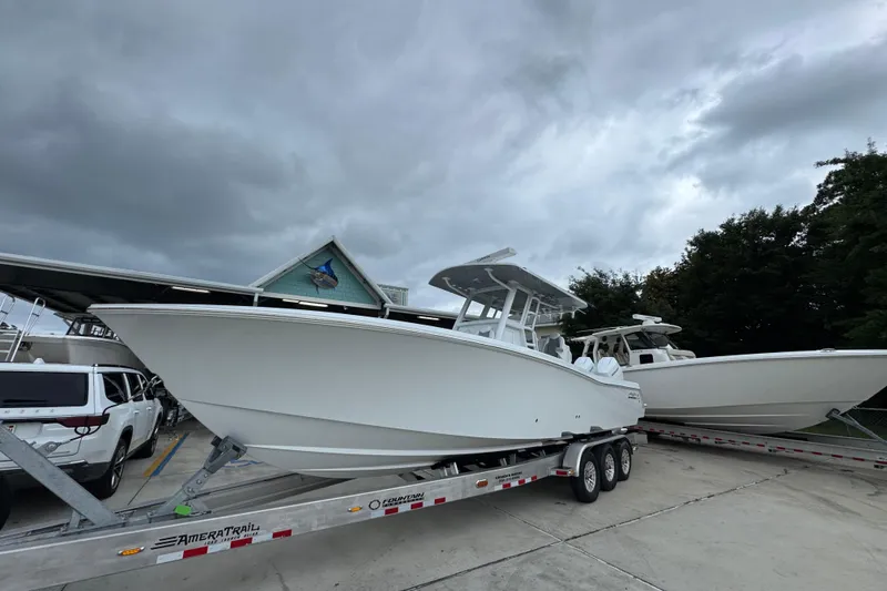 Slide: The Image of 2026 Invincible 33 Open Fisherman boat on trailer under cloudy sky. - 3