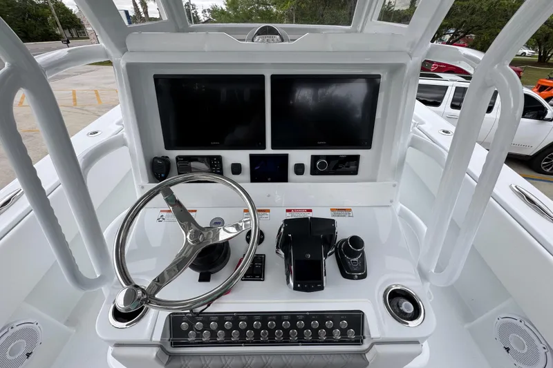 Slide: The Image of Helm of 2026 Invincible 33 Open Fisherman with dual screens and modern controls. - 32