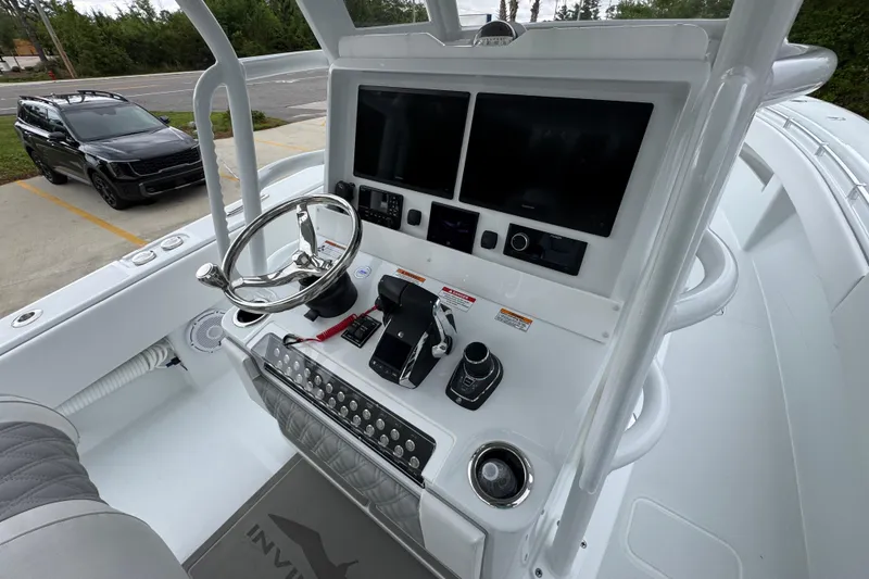 Slide: The Image of 2026 Invincible 33 Open Fisherman boat helm with advanced navigation displays and controls. - 33