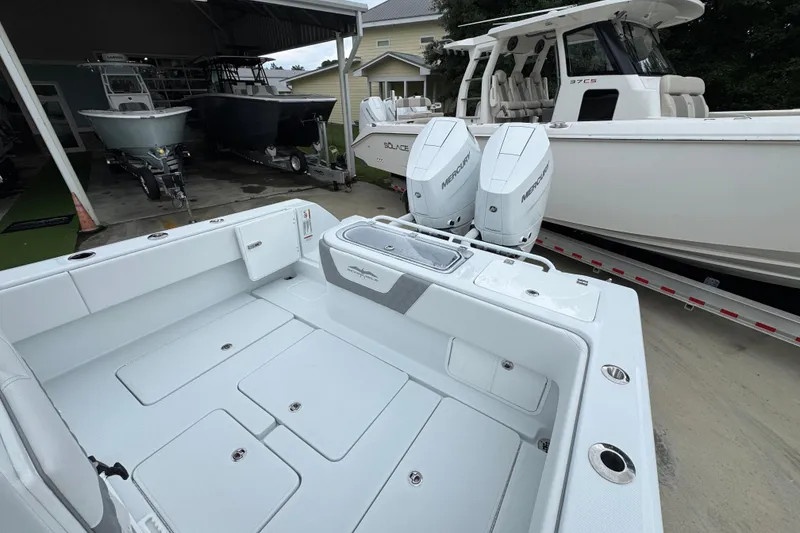 Slide: The Image of 2026 Invincible 33 Open Fisherman boat with dual Mercury engines in a showroom. - 37