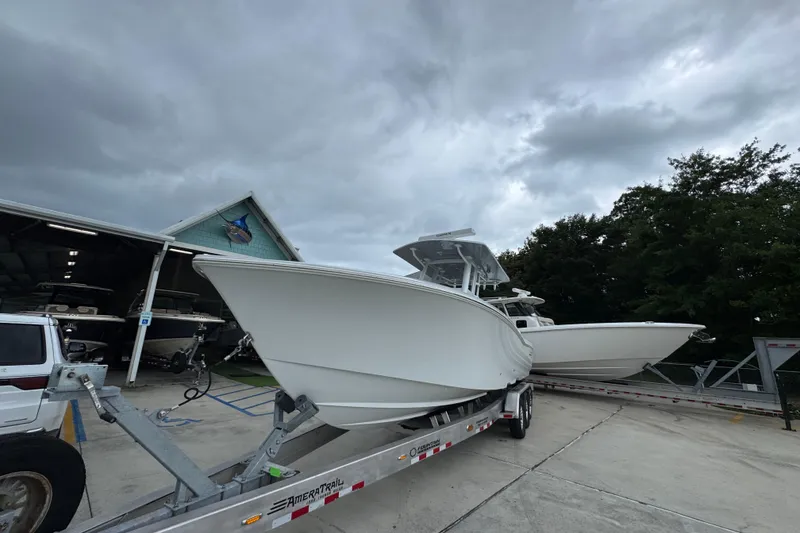 Slide: The Image of 2026 Invincible 33 Open Fisherman boat on trailer under cloudy sky. - 4