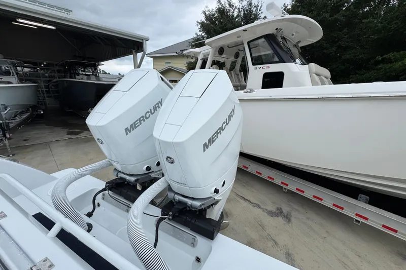 Slide: The Image of 2026 Invincible 33 Open Fisherman with dual Mercury outboard engines, parked on a trailer. - 40