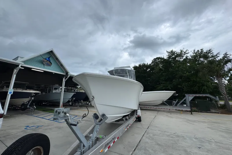 Slide: The Image of 2026 Invincible 33 Open Fisherman boat on trailer under cloudy sky. - 5