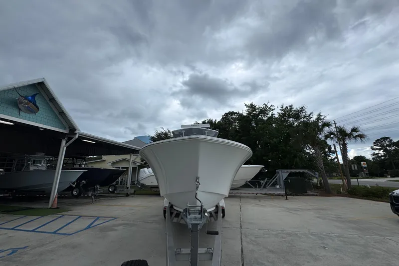 Slide: The Image of 2026 Invincible 33 Open Fisherman boat on trailer under cloudy sky. - 6