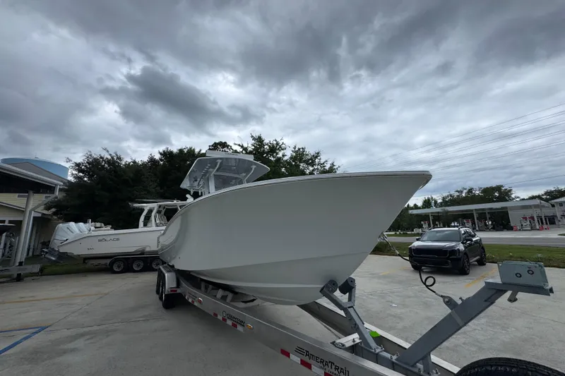 Slide: The Image of 2026 Invincible 33 Open Fisherman boat on trailer under cloudy sky. - 7
