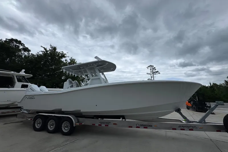 Slide: The Image of 2026 Invincible 33 Open Fisherman boat on trailer under cloudy sky. - 8