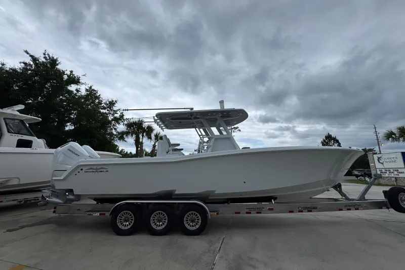 Slide: The Image of 2026 Invincible 33 Open Fisherman boat on trailer under cloudy sky. - 9