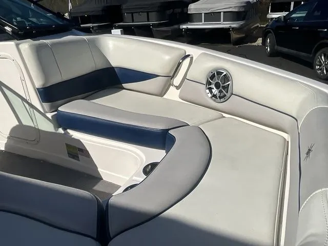Slide: The Image of Interior of a 2013 Bryant Boats 233X with white and blue seating. - 13