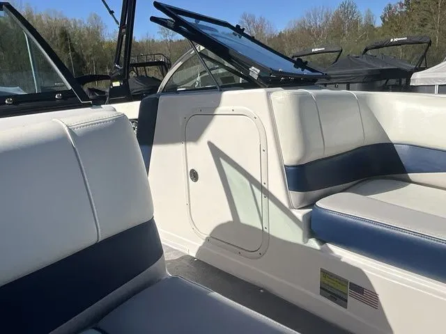 Slide: The Image of Interior of a 2013 Bryant Boats 233X with blue and white seating. - 14