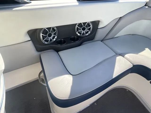 Slide: The Image of Interior of a 2013 Bryant Boats 233X with speakers and seating area. - 27