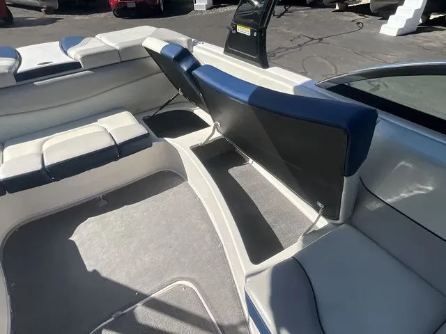 Slide: The Image of Interior of a 2013 Bryant Boats 233X with blue and white seating. - 29