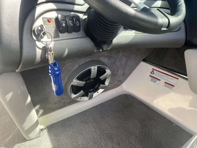 Slide: The Image of Interior of 2013 Bryant Boats 233X with speaker and ignition keys. - 33