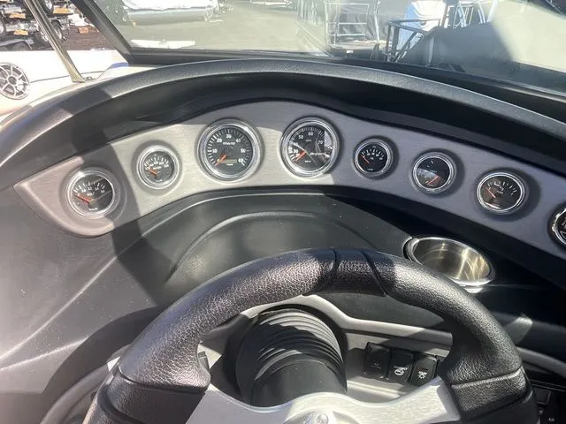Slide: The Image of Dashboard of a 2013 Bryant Boats 233X with multiple gauges. - 37