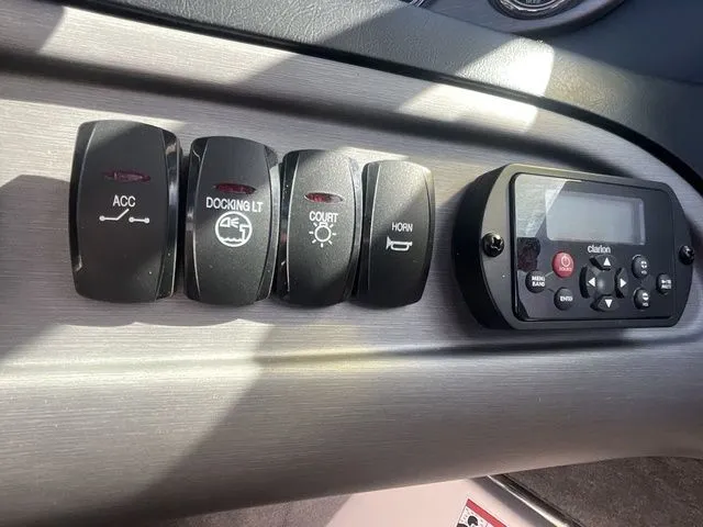 Slide: The Image of Control panel of a 2013 Bryant Boats 233X with switches. - 40