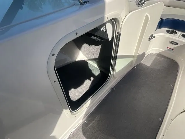 Slide: The Image of Interior of a 2013 Bryant Boats 233X with open storage compartment. - 42