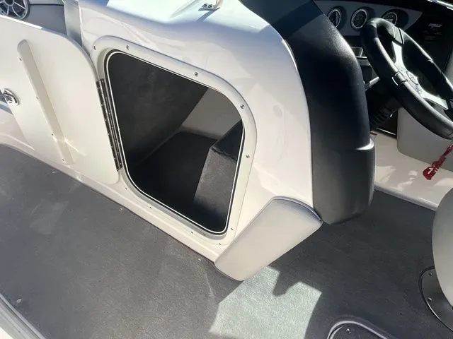 Slide: The Image of Storage compartment in the cockpit of a 2013 Bryant Boats 233X. - 43