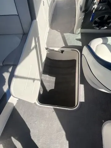 Slide: The Image of Interior of a 2013 Bryant Boats 233X with open storage compartment. - 44