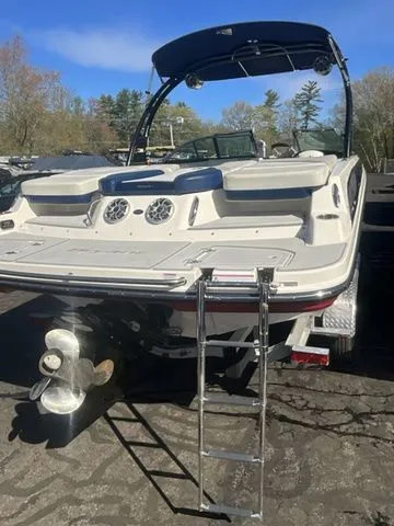 Slide: The Image of 2013 Bryant Boats 233X with ladder and propeller, parked outdoors. - 6