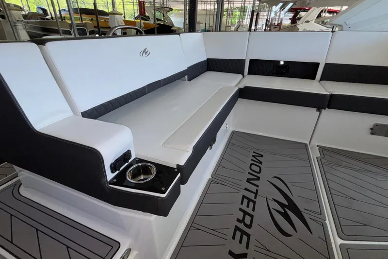 Slide: The Image of 2023 Monterey 385SS Super Sport boat interior with sleek seating and branded flooring. - 13