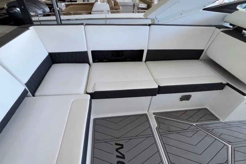 Slide: The Image of Luxurious seating area on 2023 Monterey 385SS Super Sport boat, featuring sleek white and black upholstery. - 14